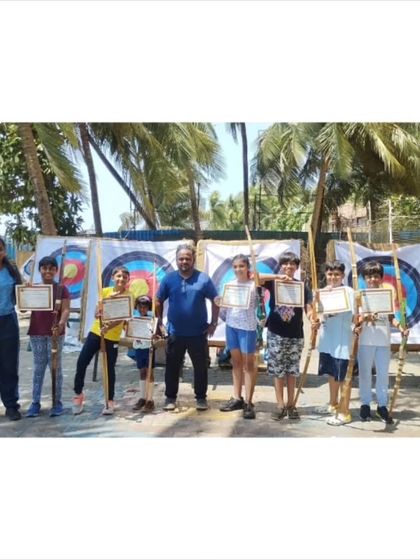 A group of young archers from our 2024 summer camp posing with their completion certificates.