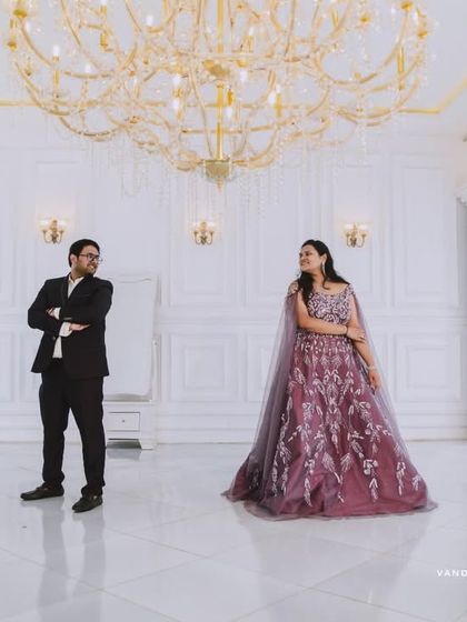 An all-white, classic European-style studio sets the stage for pure romance. The grand piano and crystal chandelier add a touch of musical elegance to this couple's pre-wedding photos.