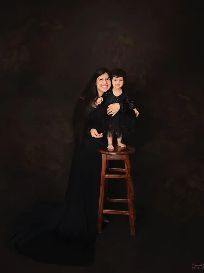 A beautiful mommy-daughter moment. The matching black dresses create a classic and elegant look for this timeless portrait.