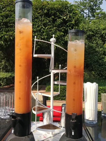 To ensure guests are served quickly at large events, I use these tall beverage towers. They are filled with pre-mixed mocktails and iced tea, allowing for fast refills and preventing long queues at the bar.