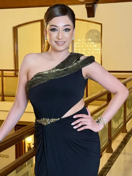 The client looks confident and happy with her modern prom hairstyle. The sleek ponytail is a timeless choice that never goes out of style.