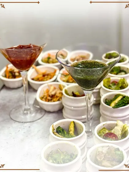 An artistic presentation of our appetizers. We use unique serving dishes like these stacked pots and martini glasses to create a visually stunning food display.
