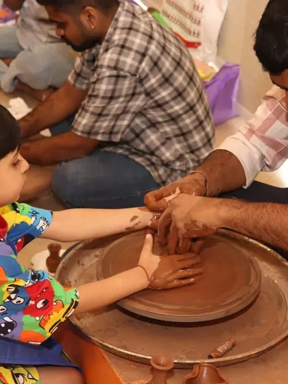 It's not just for kids. Our activities are designed to bring families together. Moments like these, where a parent and child create something together at the pottery wheel, make corporate family days truly special and memorable.