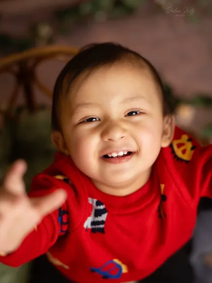 A close up shot capturing a big, toothy grin. This is pure, unfiltered happiness, and it's what milestone sessions are all about.