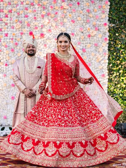 A beautiful formal portrait of the couple against their floral wedding backdrop.