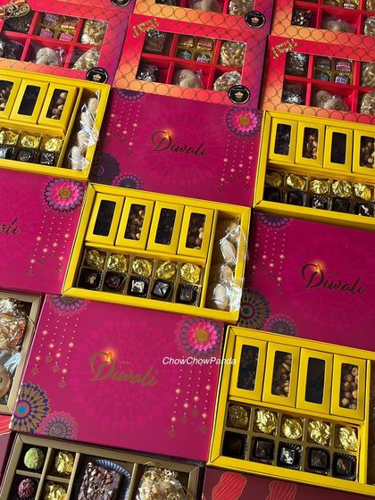 An overhead view of some of the different Diwali hampers I offered. You can see the variety in box colours and the assortment of sweets inside each one.