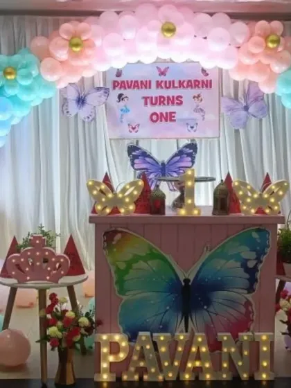 This enchanting butterfly theme is perfect for a first birthday. I created a full rainbow pastel balloon arch with floral details, a custom dessert table, and light-up butterfly and name props.