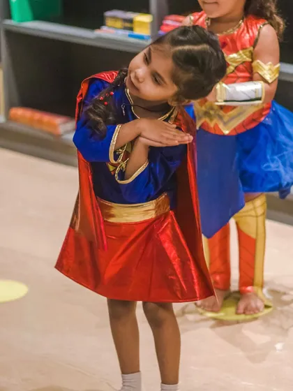 Another Supergirl, focused and ready. We teach kids to hold their poses with strength and character.