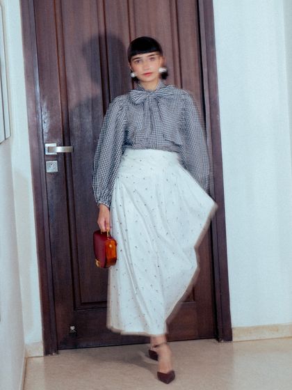 A motion shot capturing the flow and asymmetry of my black and white outfit for the GQ Christmas party.