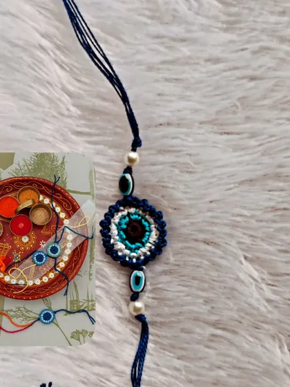 The evil eye rakhi, a symbol of protection, ready to be placed on the puja thali. It is one of my most requested designs.