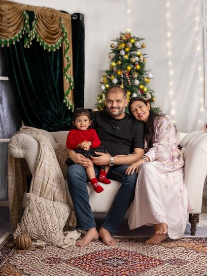 A full family portrait showcasing their relaxed and happy bond. Christmas photoshoots are a wonderful tradition to capture your family's growth each year.