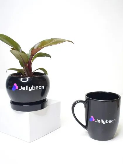 A matching set of a branded plant pot and mug for Jellybean. The sleek black finish with the colorful logo creates a modern and stylish gift.