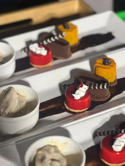 A sweet finale, plated to perfection. This dessert trio, featuring a vibrant berry mousse, a rich chocolate creation, and a scoop of artisanal ice cream, demonstrates our flair for creating elegant, individual desserts for sit-down dinners and special occasions.