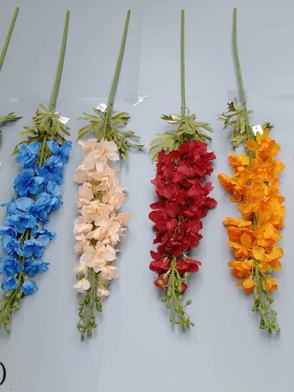 Brightly colored artificial flower sticks in blue, peach, red, and orange.