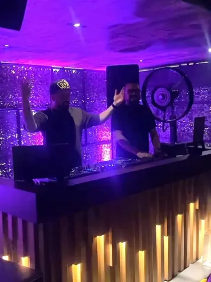 Waving to the crowd from the DJ booth at Kaze. It's a two-way energy exchange.