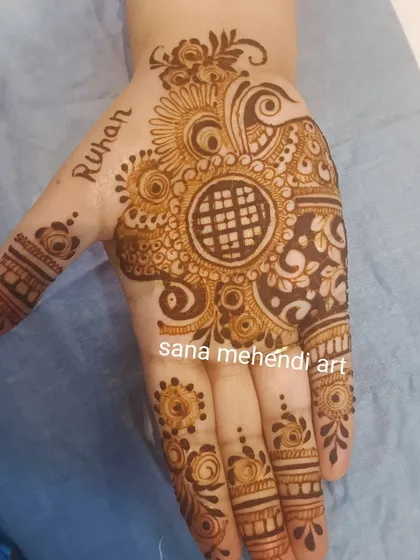 A lovely single-hand design with a central mandala and the name 'Ruhan' written on the side. This is a great option for a quick and beautiful festive touch.