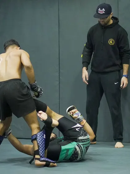 A coach watches over a sparring session, providing guidance and ensuring the training is both safe and effective. Our coaching is hands-on and detail-oriented.