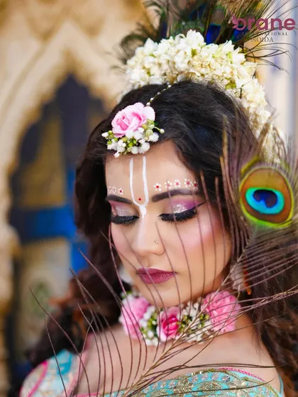 A close-up on the eye makeup, featuring shimmering pink and purple tones and delicate white dot work.