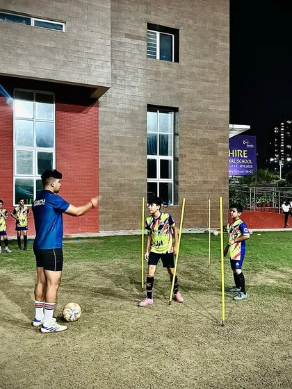 A coach demonstrating a drill to our U13 Elite Squad. Our licensed coaches provide hands-on instruction to ensure every player masters the correct technique.