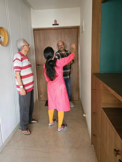 Working with a family at the entrance of their home. The main door is the mouth of the house, and its Vastu compliance is vital for attracting positive opportunities.