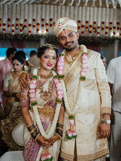 Capturing the joy of a wedding day. This happy couple showcases how a coordinated look comes together. The groom is wearing a custom hand-embroidered pure silk sherwani that I designed to match the tones and elegance of the bride's saree.