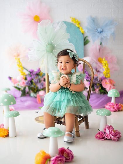 Pure happiness! Her joyful expression is perfectly captured in this colorful garden setting.