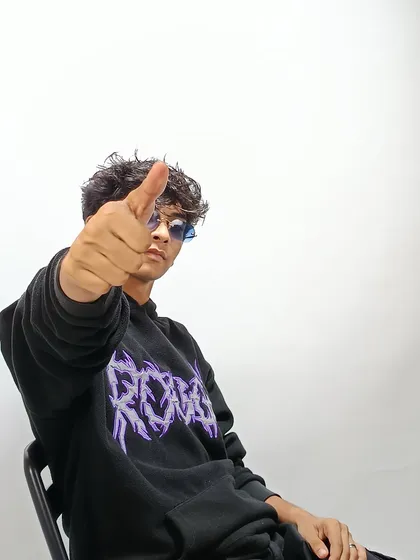 A confident shot from the same artist's session, showing a different side of his personality.