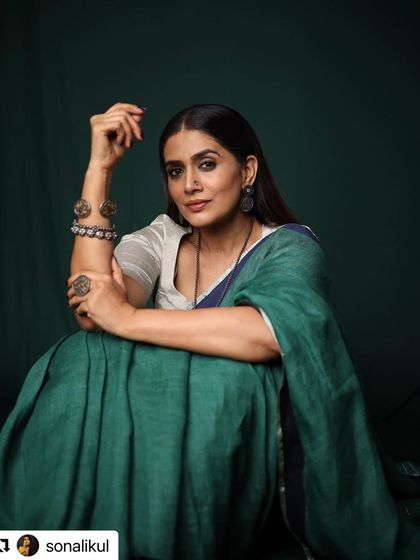 Another portrait of Sonali Kulkarni in the elegant green Anavila saree. The focus here is on her expressive posture and the beautiful drape of the fabric. This shot highlights how the right styling can empower an artist to connect with the camera so effortlessly.