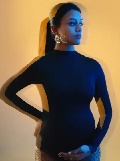 This image showcases the use of colored gels and double exposure effects to create a modern, artistic maternity portrait.