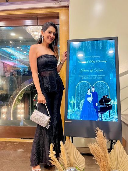 This digital welcome board for a Sangeet and Ring Ceremony looks so sleek. The design has a "Starry Night" theme with a deep blue background, piano illustration, and a glamorous caricature of the couple.
