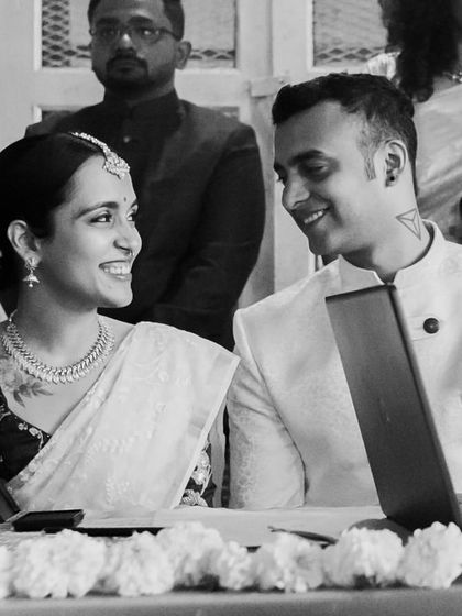 A quiet moment of connection during the registered ceremony. The way they look at each other speaks volumes, a candid black and white shot that feels both intimate and official.