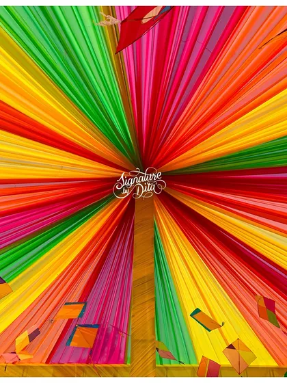 Looking up into the rainbow-draped canopy with kite details. This immersive ceiling treatment surrounded guests in color and added to the festive, celebratory feeling of the event.