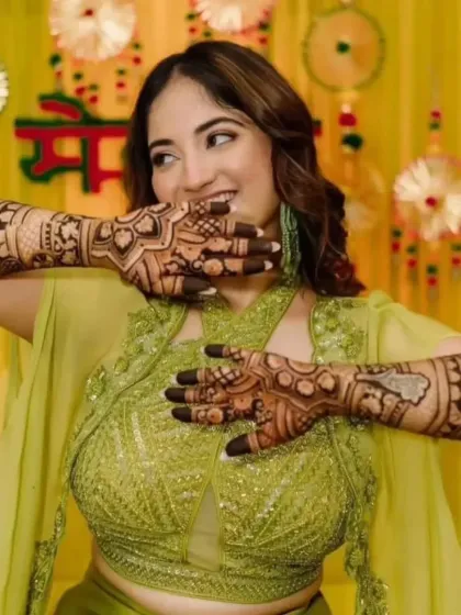 A playful and happy bride at her mehandi function.
