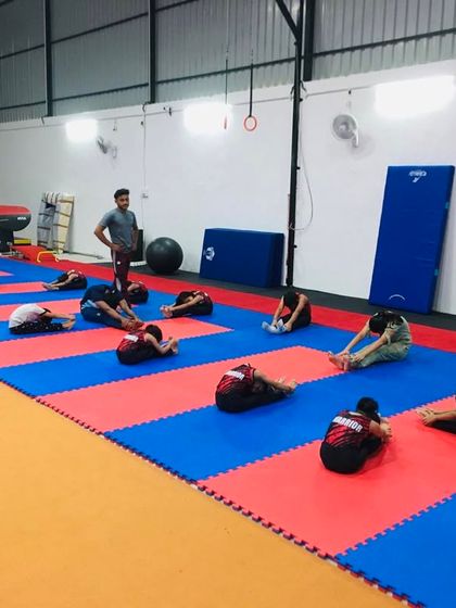 A classic stretching session in progress. Coordinated group work like this ensures every student understands the importance of flexibility and proper form from the start.