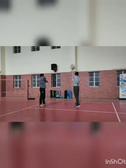 We offer both group and personal coaching to suit every player's needs. This photo from a one-on-one badminton session highlights the focused attention we provide to help players refine their technique.