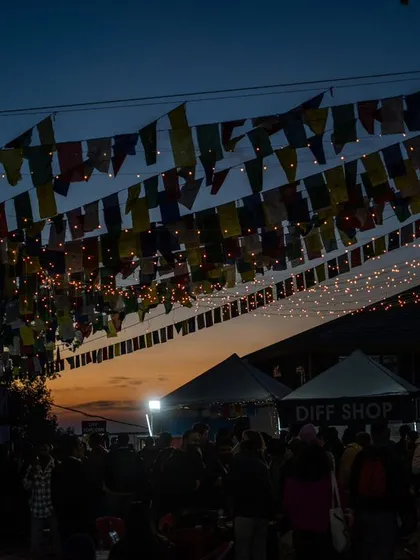 This shot from the Dharamshala International Film Festival captures the magical atmosphere as dusk settles in. The prayer flags against the sunset sky create a sense of community and shared passion for cinema, a feeling I always aim to bring into my festival photography.