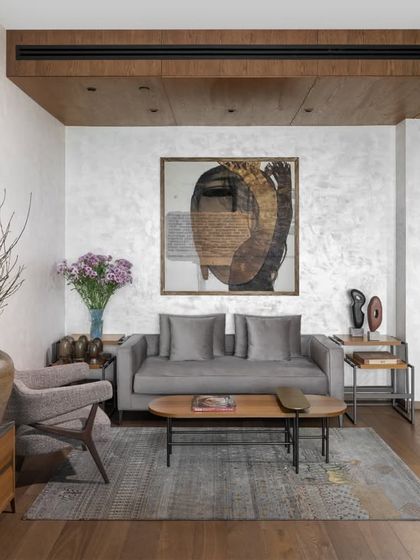 Another angle of the master bedroom's sitting area, highlighting the layering of textures and materials. The wood-paneled ceiling drop-down defines the space, while the mix of our custom furniture and collected accessories adds a personal, curated feel.