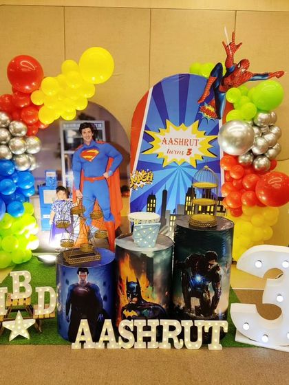 An action-packed superhero theme for a 3rd birthday. We assembled the mightiest heroes with life-sized cutouts of Superman, Batman, Hulk, and Spider-Man, complete with a city-scape backdrop and bold, primary-colored balloon decorations.