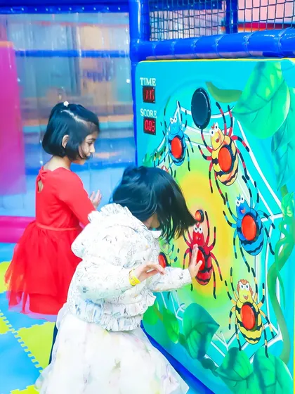 Friends team up to score points on the interactive spider-themed wall game. It’s a great way to encourage friendly competition during a birthday party.