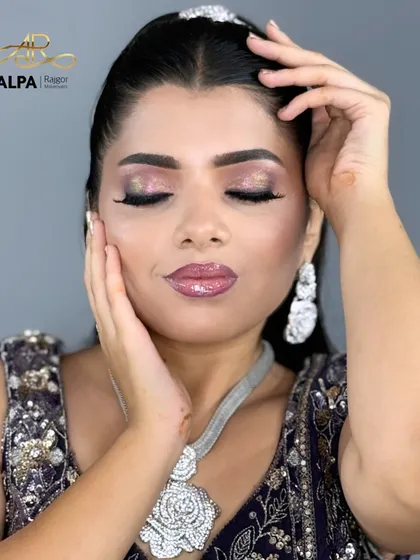 A close-up on the purple glitter eye makeup, a perfect choice for a vibrant Sangeet night.