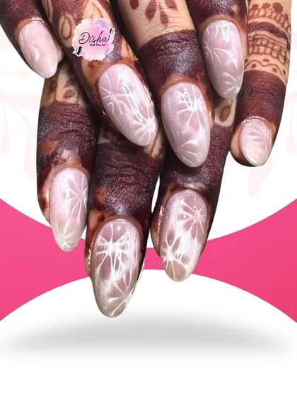 Mehendi and nails are the perfect pair. This beautiful design with intricate white patterns looks stunning against the dark henna, perfect for a bride.