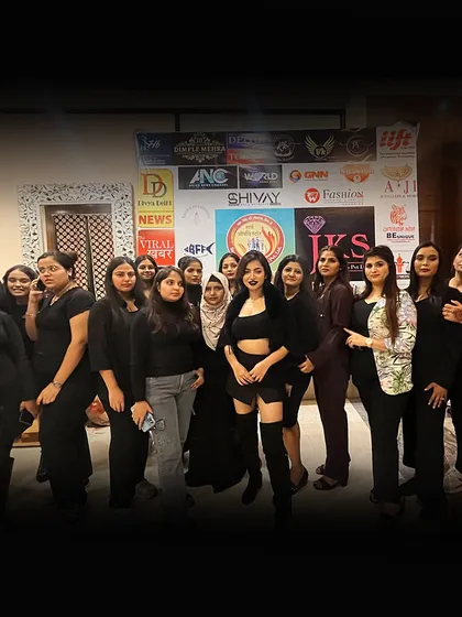 Our students posing as a team during a fashion show internship. This is where they learn teamwork and professionalism in a high-pressure environment.