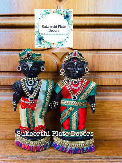 A beautifully decorated Marapachi couple, sent to a client in Thrissur for her baby shower. The dolls are adorned with rich fabrics and stone-work jewellery.