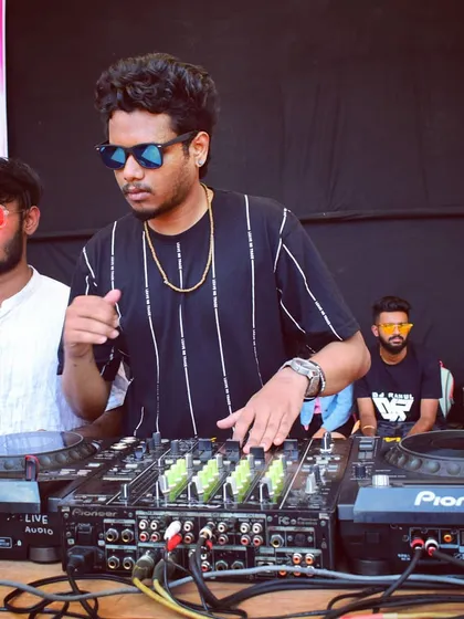 In the zone during the Bengaluru Holi Utsav. I'm focused on the mix, blending hard trance and Bollywood tracks on my Pioneer DJ gear to keep the festival energy at its peak.