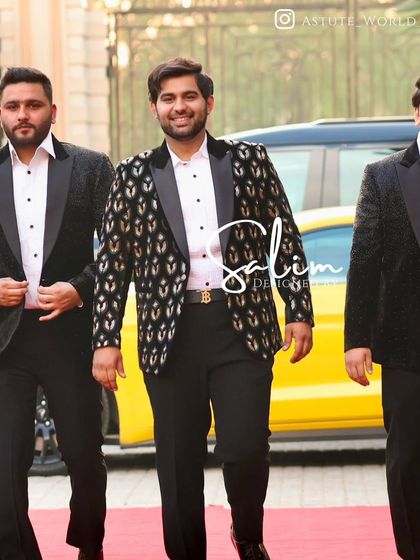 A group of friends arriving at an event, with the man in the center wearing my patterned velvet tuxedo. It shows how my designs stand out in a crowd.