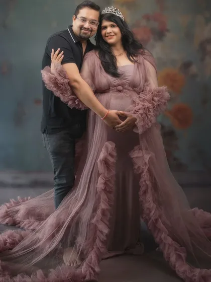 A portrait fit for royalty. The flowing gown, the crown, and the soft, painterly background create a dreamy, fairytale atmosphere. Their loving embrace completes this beautiful picture of anticipation.