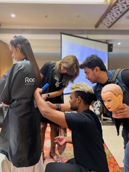 A collaborative moment at a workshop, where I'm guiding other stylists as they practice the techniques.