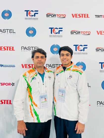 Coach Praveen Sharma with athlete Lakshya Sharma at the FIG World Cup in Turkey. Our coaching extends to the highest levels of international competition.