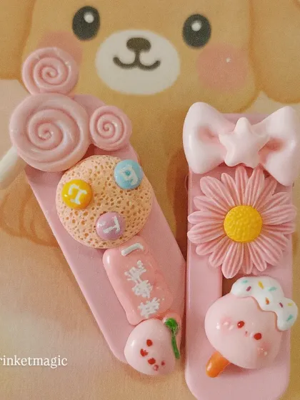 Pretty in pink! This handmade hair clip is loaded with sweet charms like a cookie, a flower, and a little ice cream cone. It’s a perfect example of the detailed, cute accessories I love to create.