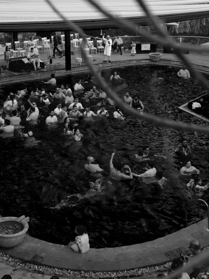 A black and white aerial view of the Haldi pool party, capturing the scale of the fun and the number of guests enjoying the unique celebration.